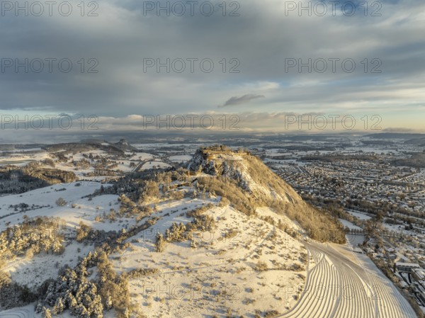 Aerial view of the snow-covered Hegau volcano Hohentwiel with Germany's largest castle ruins on a