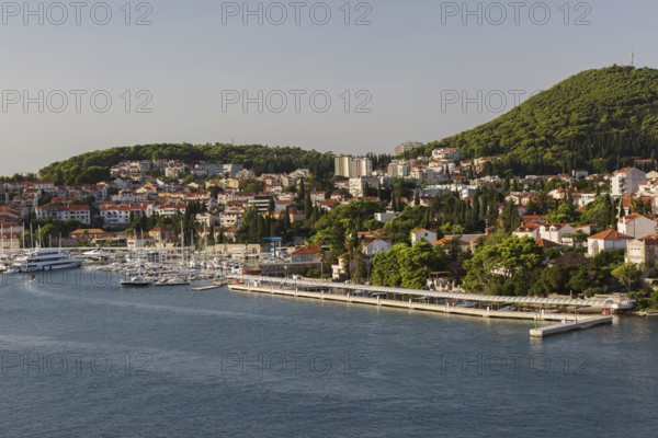 High angle view of tan and white trim houses and villas with traditional terracotta clay tile