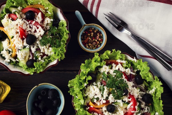 Traditional Bulgarian dish, Shopska salad, on a wooden table, salad of fresh vegetables, top view,