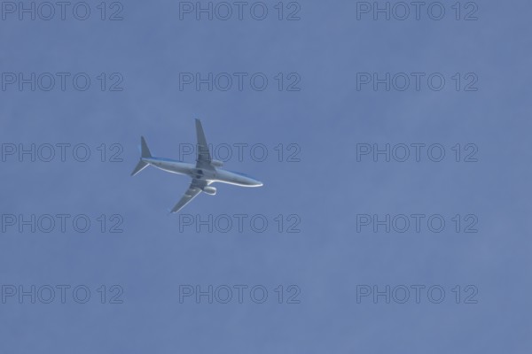 Boeing 737 jet passenger aircraft of TUI holidays flying in a blue sky, England, United Kingdom,