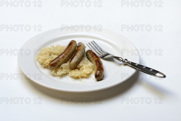 Nuremberg sausages with sauerkraut on a plate, Rostbratwurst, Germany, Europe