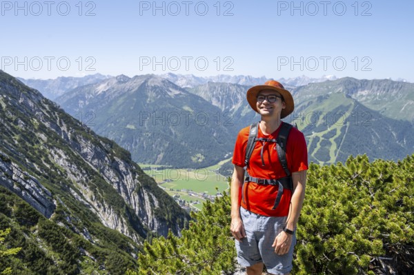 Mountaineer on a hiking trail between mountain pines, mountaineer climbing the Hochunnütz, Unnütz