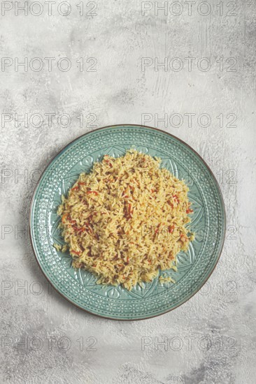 Basmati rice with saffron, on a decorative blue plate, light background, homemade, no people