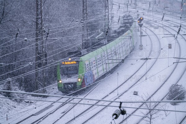 Winter weather, heavy snowfall, railway tracks in front of Essen main station, S-Bahn train, North
