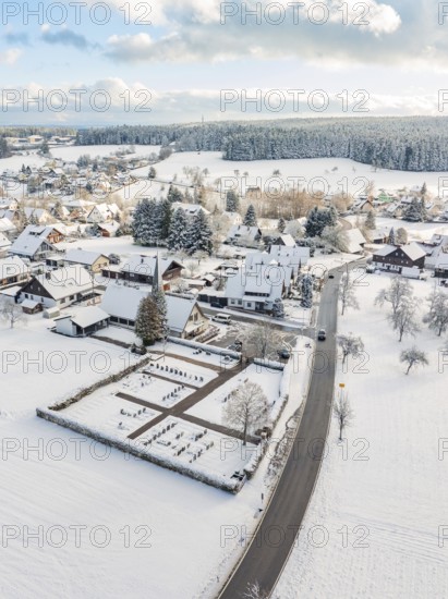 Snow-covered village with church and surrounding snow-covered buildings, Oberreichenbach, Black