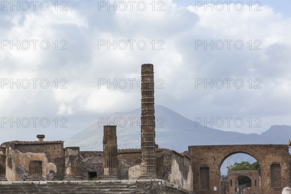 Old stone columns supported by braces and terracotta brick wall building structures plus view of