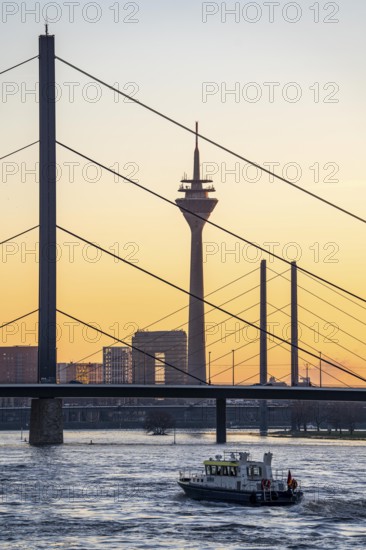 Sunset on the Rhine near Düsseldorf, skyline of the city centre with Rhine Tower, Rheinkniebrücke,