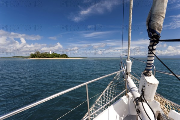 Sailing, sailing ship off uninhabited coral island Low Island near Port Douglas, Barrier reef,