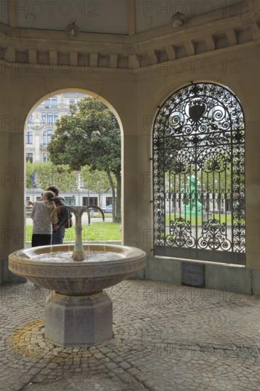 Interior view of the pavilion with Kochbrunnen at Kochbrunnenplatz, metal grid, persons, two,