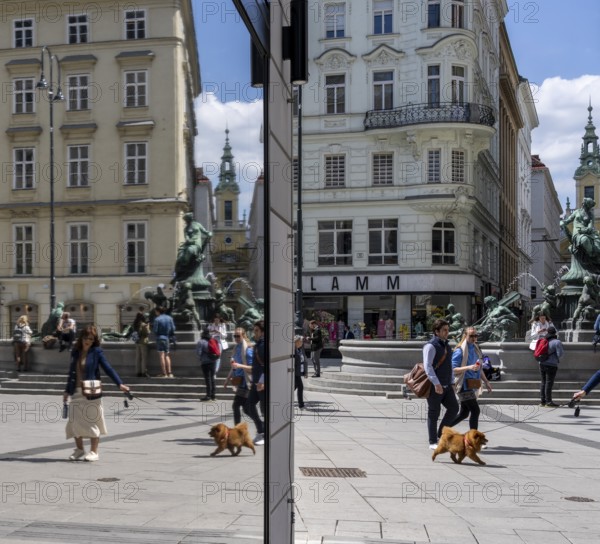 Pedestrians reflected in a shop window, Kärntner Straße at Donnerbrunnen, Vienna, Austria, Europe
