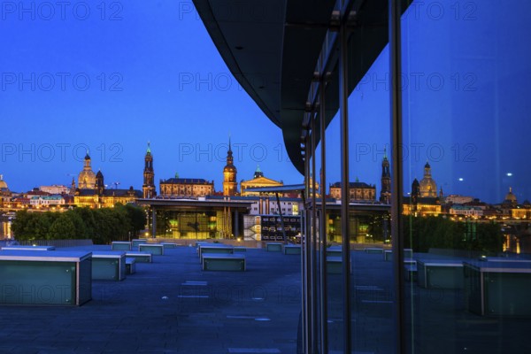Reflection of the illuminated Old Town of Dresden in the façade of the Dresden Congress Centre