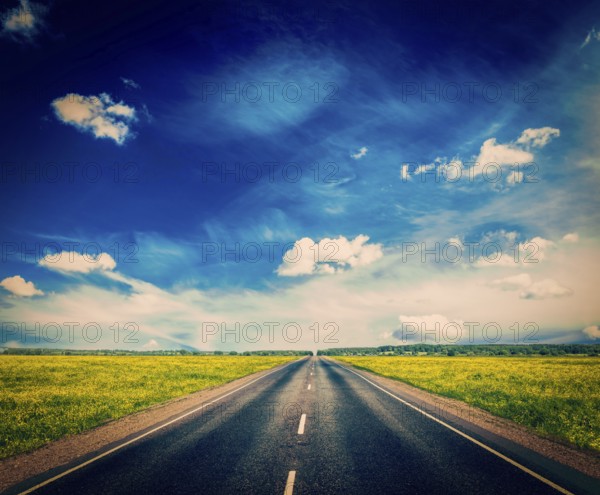 Vintage retro effect filtered hipster style image of travel concept background, road in blooming