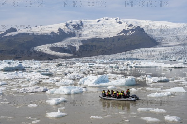 Boats with tourists in the glacier lagoon, ice lagoon Fjallsárlón, ice floes in front of glacier