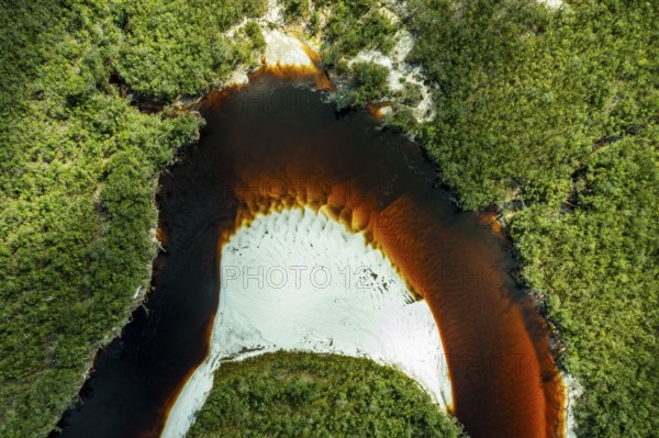Black river and white sand beach before the granite hills, Cerros de Mavecure, Eastern Colombia
