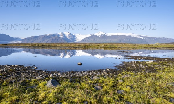 Reflection in a lake, view of glacier tongues Skaftafellsjökull and Svínafellskökull, glaciated