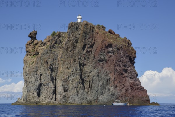 Rock island Strombolicchio with lighthouse, near island Stromboli, Lipari Islands, Tyrrhenian Sea,
