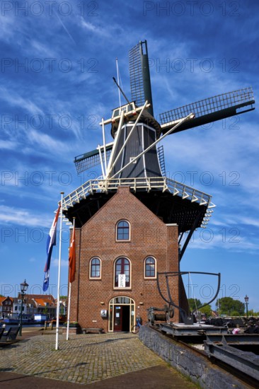 HAARLEM, NETHERLANDS, MAY 6, 2017: Windmill De Adriaan on Spaarne river. Harlem, Netherlands. The