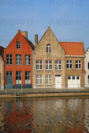 Typical Belgian cityscape Europe tourism concept, canal and old houses on sunset. Bruges (Brugge),