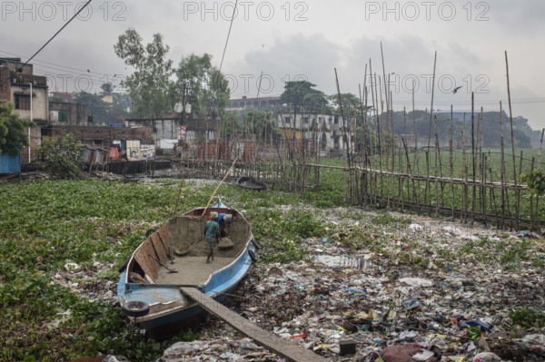 Construction workers transporting sand from a boat over a plank, Tel Ghat, Dhaka, Bangladesh, Asia