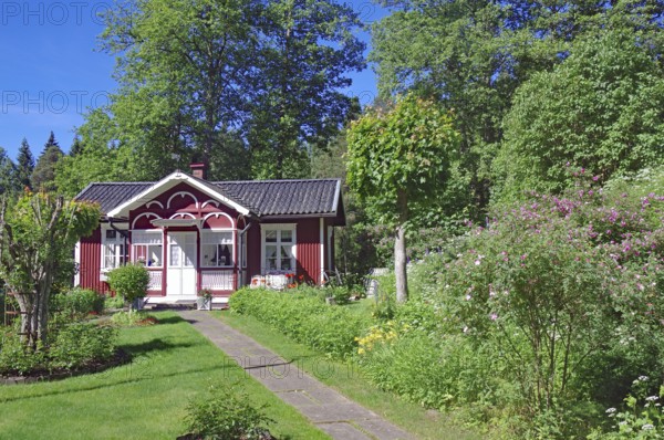 Small red wooden house in a garden, idyll, lock-keeper's house, Dalsland Canal, Sweden, Europe