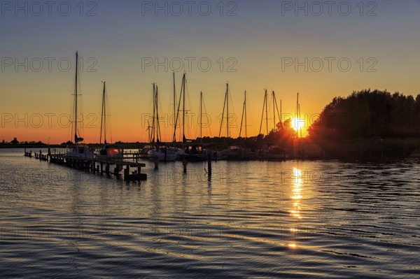 Sailing boats at sunset, waterway rest area, backlight, Wustrow harbour, Saaler Bodden, Fischland,