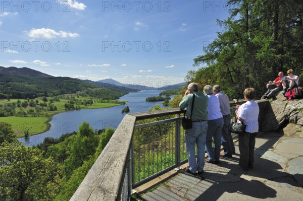 Tourists looking over Loch Tummel from Queens 's View near Pitlochry in Perth and Kinross,