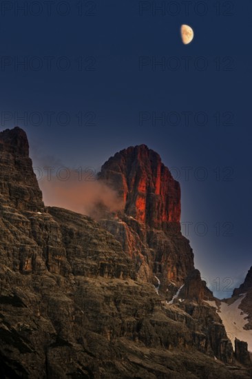Alpine glow at sunset over Monte Cristallo mountain in the Dolomites, Italy, Europe