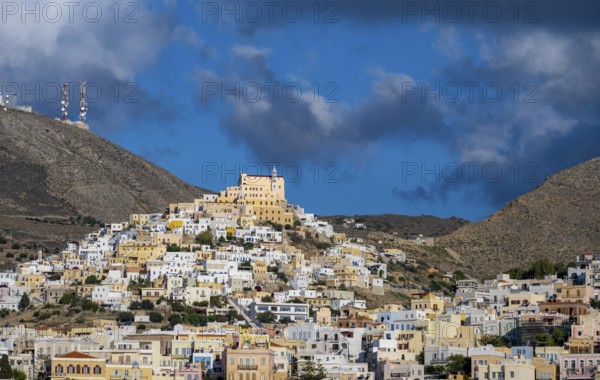 View of the town of Ermoupoli with pastel-coloured houses, on the hill Basilica of San Giorgio in