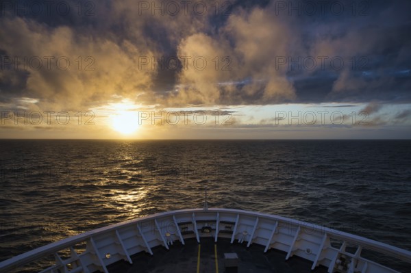 View from the ferry King Seaways of an atmospheric sunset with dramatic clouds over the North Sea,