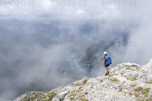 Mountaineer on the Waxenstein with fog, Wetterstein Mountains, Garmisch-Patenkirchen, Bavaria,