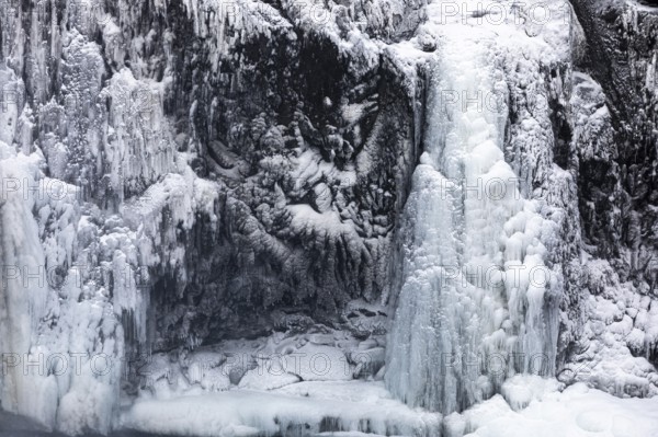 Iced and snow-covered rock face, at Godafoss waterfall, Northern Iceland Eyestra, Iceland, Europe