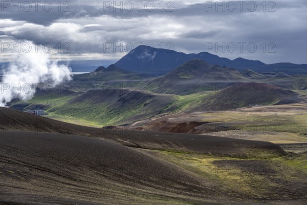 Volcanic landscape with colourful hills, steam of the Krafla geothermal power plant, geothermal