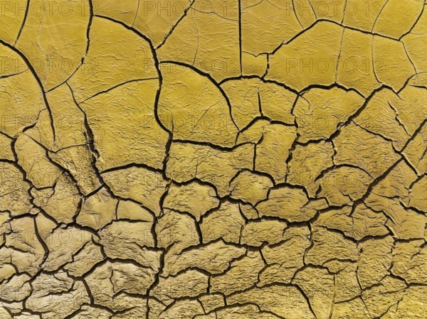 Mineral-rich cracked earth at the bank of the Rio Tinto (Red river), aerial view, drone shot,