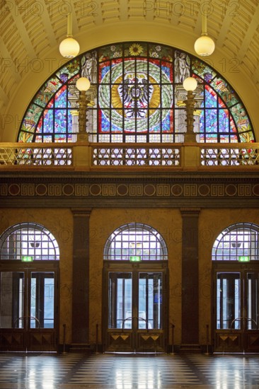 Entrance area with glass window, illuminated foyer in the spa hotel and casino in the evening,