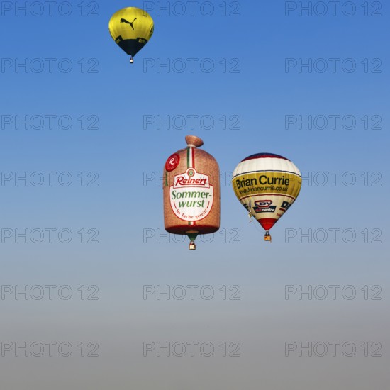 Three hot-air balloons travelling in the blue sky, advertising for Reinert Sommerwurst, BVB, Brian