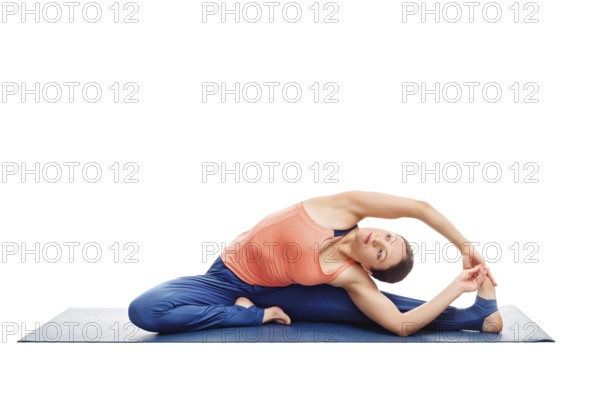 Beautiful sporty fit woman doing yoga asana parivrtta janu sirsasana, revolved head-to-knee pose