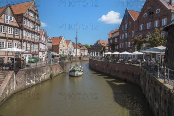 Historic merchant and warehouse houses at the Hanseatic harbour with the sailing ship Willi, Old
