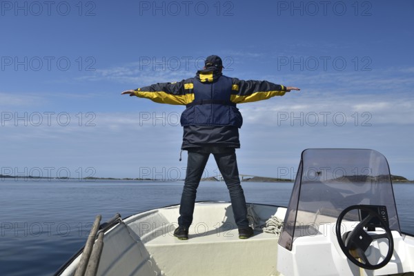 Senior, man on a motorboat on the Atlantic Road in Norway
