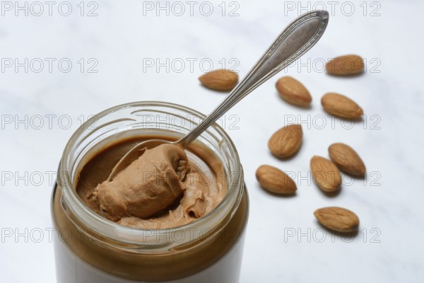 Almond cream in jar with spoon, almond spread