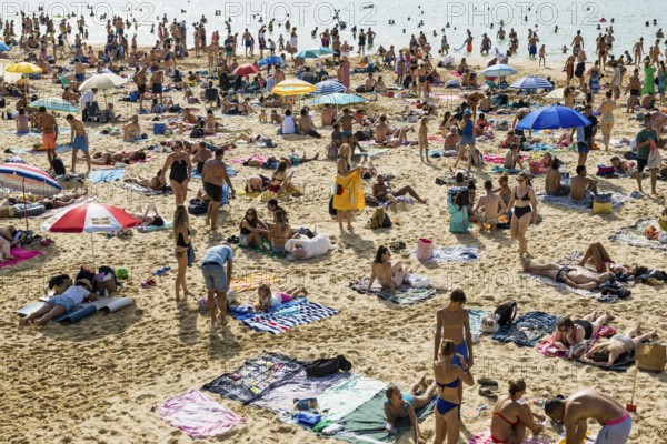 Crowded beach with people in August, San Sebastian, Donostia, Basque Country, Northern Spain,