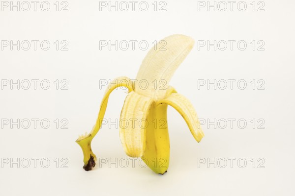 Half peeled banana, studio shot, white background, healthy diet