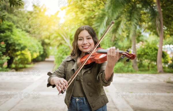 Young woman playing the violin outdoors. Portrait of a girl playing the violin outdoors, Close up