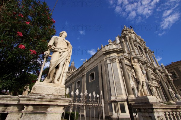 Super wide angle, oblique from below, sculpture, cathedral, blue sky, white clouds, Catania, Old