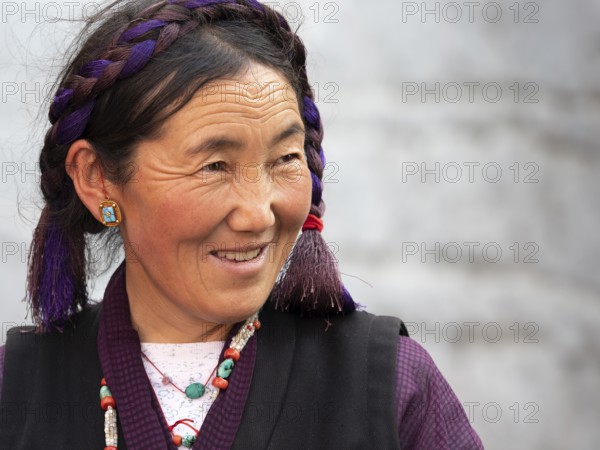 Tibetan woman with braid, laughing, pilgrim in Xigaze, Tibet, China, Asia