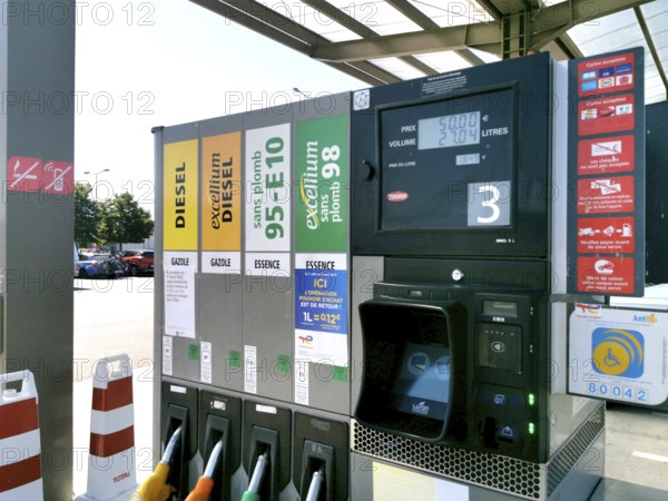 Petrol pump with nozzles for petrol and diesel at a motorway filling station in France, Automatic
