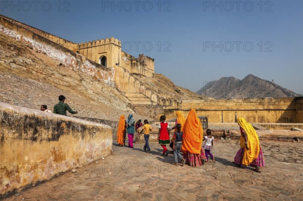 AMER, INDIA, NOVEMBER 18, 2012: Visitors (women in Rajasthani attire) going to Amer (Amber) fort.