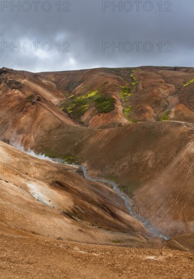Steaming stream between colourful rhyolite mountains, Hveradalir geothermal area, Kerlingarfjöll,