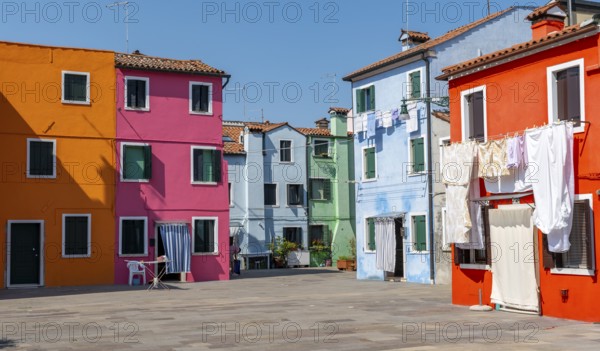 Colourful houses with washing lines, colourful house facades, alleyways on the island of Burano,