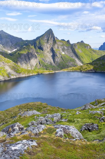 Mountain landscape with lake Tennesvatnet and rocky pointed mountain peak, at sunrise, Moskenesøya,
