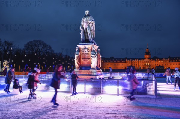 Ice skating rink on Schlossplatz, Karlsruhe Castle in the background, Karlsruhe, Baden-Württemberg,